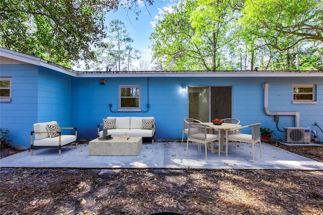 view of patio / terrace with an outdoor living space and ac unit