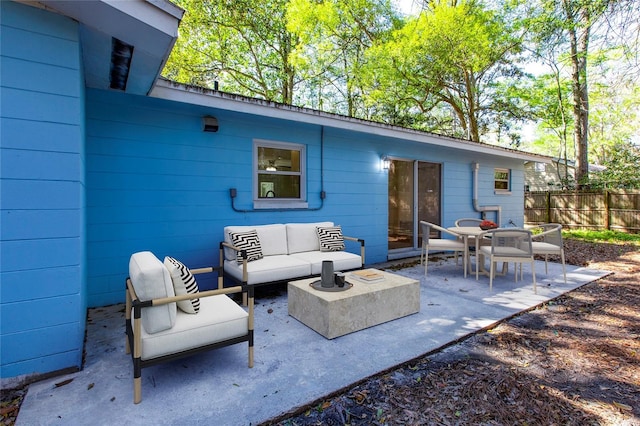 view of patio featuring an outdoor living space and fence