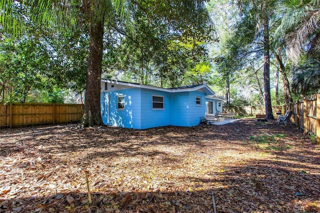 exterior space with entry steps and a fenced backyard