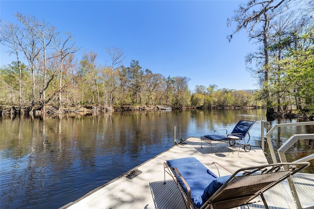 dock area featuring a view of trees and a water view