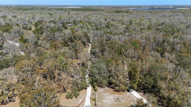 birds eye view of property featuring a wooded view