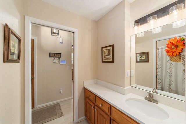 bathroom with baseboards and vanity