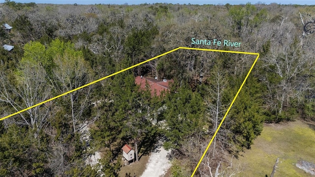 birds eye view of property with a forest view