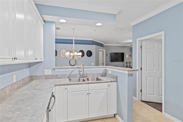 kitchen featuring light countertops, ornamental molding, a peninsula, white cabinetry, and a sink