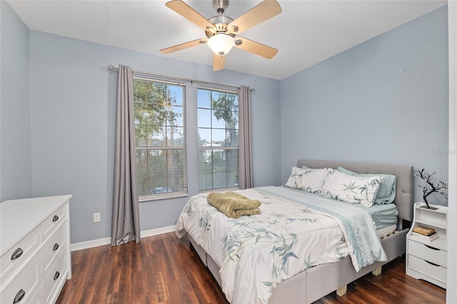 bedroom with dark wood-style floors, a ceiling fan, and baseboards