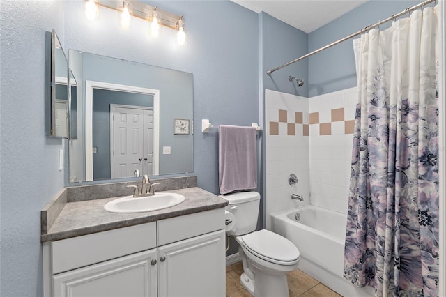 full bathroom featuring toilet, shower / tub combo with curtain, a textured wall, tile patterned floors, and vanity