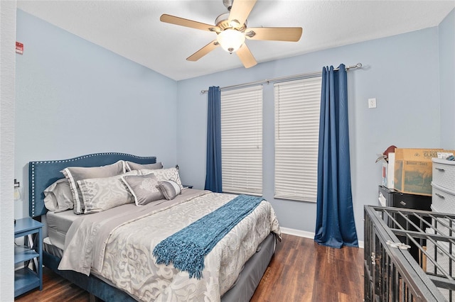 bedroom with ceiling fan, baseboards, and wood finished floors