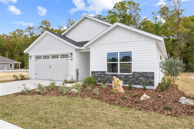 view of front of home featuring stone siding, board and batten siding, concrete driveway, and a garage