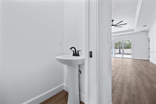 bathroom featuring visible vents, baseboards, a raised ceiling, and wood finished floors