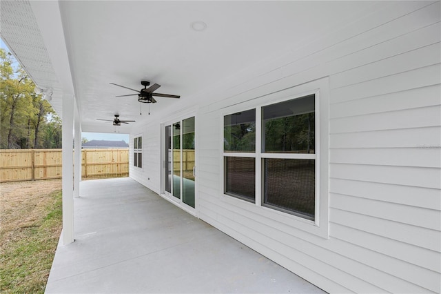 view of patio with ceiling fan and fence