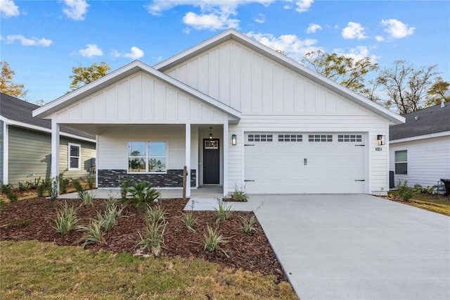 view of front facade featuring a porch, an attached garage, board and batten siding, and driveway