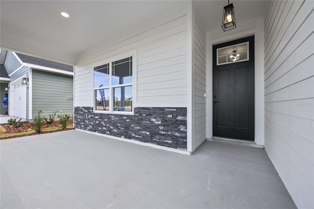 view of exterior entry featuring stone siding