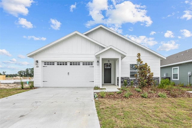 view of front facade featuring a garage, driveway, and board and batten siding