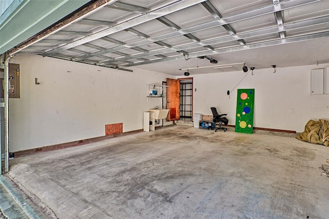 garage with a sink and baseboards