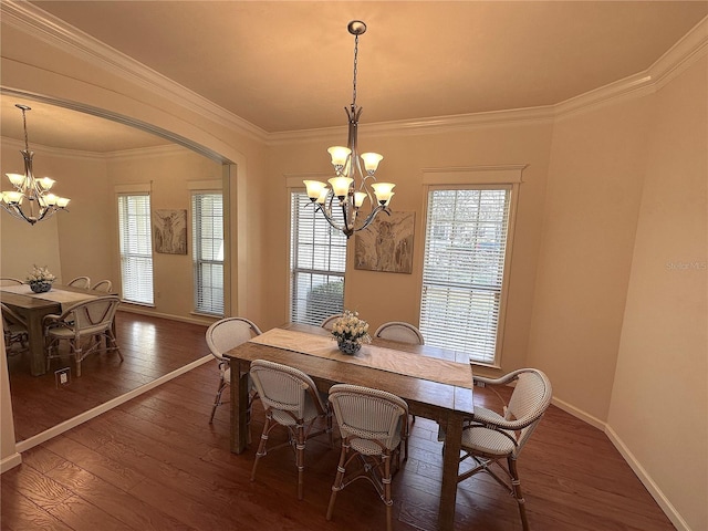 dining space featuring a wealth of natural light, a notable chandelier, and hardwood / wood-style floors