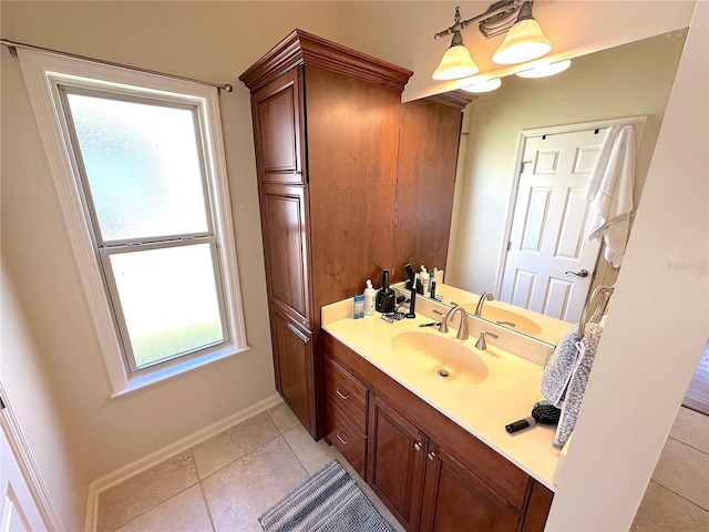 bathroom featuring tile patterned floors, vanity, and baseboards