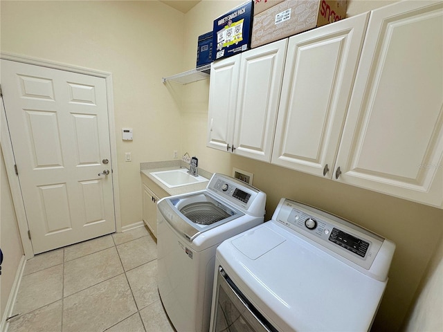 laundry room with washing machine and clothes dryer, baseboards, light tile patterned floors, cabinet space, and a sink