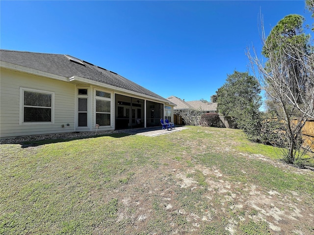 view of yard with a patio area, a fenced backyard, and a sunroom