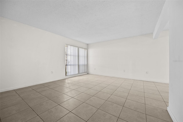 unfurnished room featuring baseboards and a textured ceiling