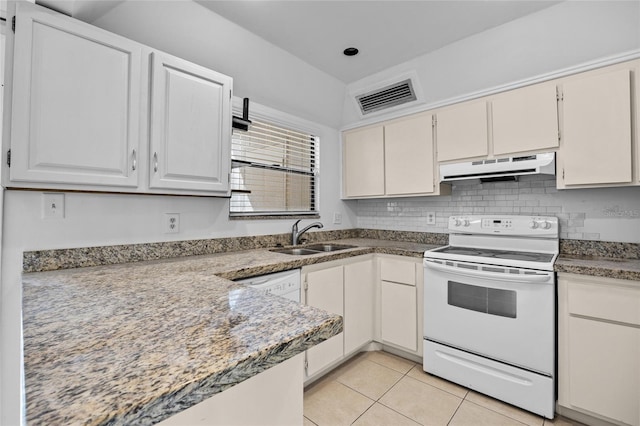 kitchen featuring white appliances, light tile patterned floors, visible vents, a sink, and under cabinet range hood