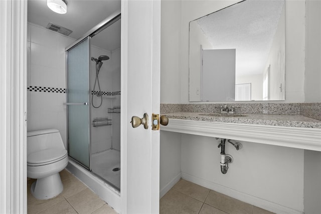 full bath featuring tile patterned flooring, visible vents, a stall shower, and toilet