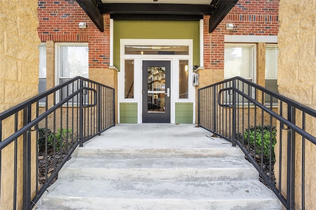 doorway to property featuring brick siding