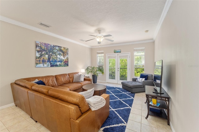 living area featuring light tile patterned floors, a ceiling fan, baseboards, visible vents, and ornamental molding