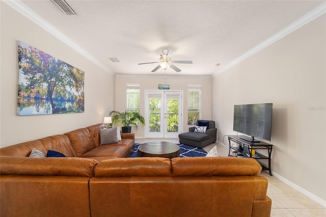 living room with visible vents, baseboards, ceiling fan, and ornamental molding