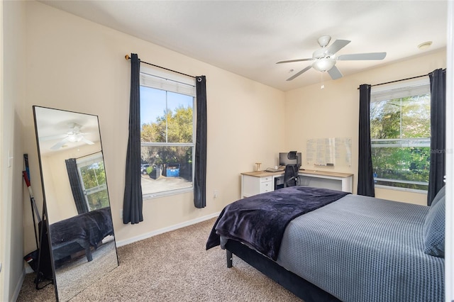 carpeted bedroom with a ceiling fan and baseboards