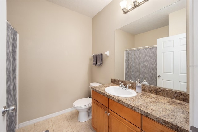 bathroom featuring tile patterned floors, toilet, vanity, and baseboards