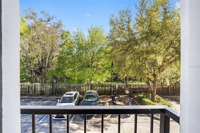 exterior space featuring a balcony and fence