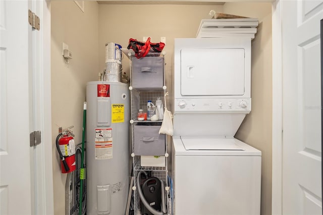 clothes washing area with water heater, laundry area, and stacked washer and clothes dryer