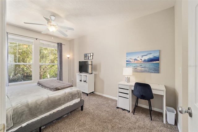 bedroom with ceiling fan, a textured ceiling, baseboards, and carpet floors