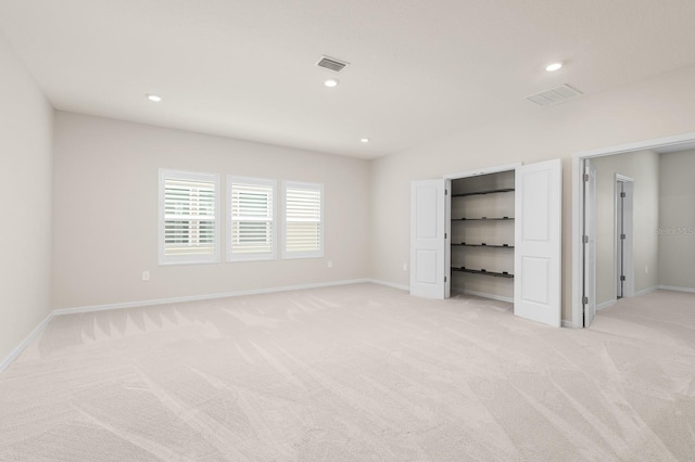 unfurnished bedroom featuring light carpet, visible vents, and recessed lighting