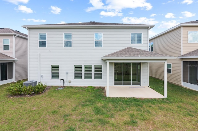 rear view of property with a yard, a patio area, and central AC