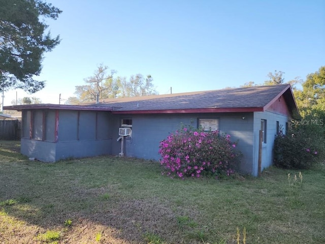 rear view of property featuring cooling unit and a yard