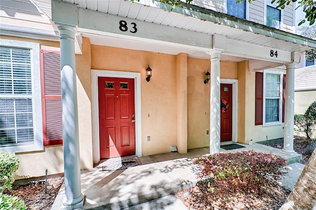 property entrance featuring stucco siding