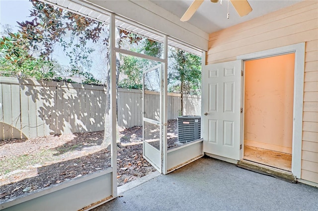 unfurnished sunroom with a ceiling fan