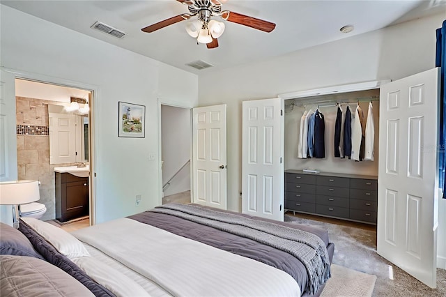2508 SW 35th Pl Unit N83, Gainesville, FL 32608 - bedroom with a closet, light carpet, ceiling fan, and ensuite bath