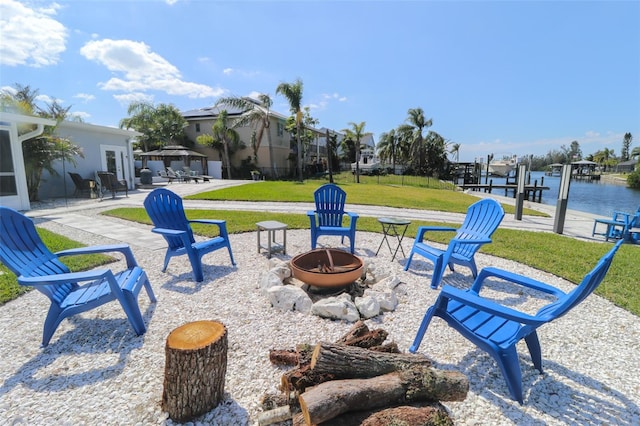 view of patio / terrace featuring a gazebo, a dock, and an outdoor fire pit