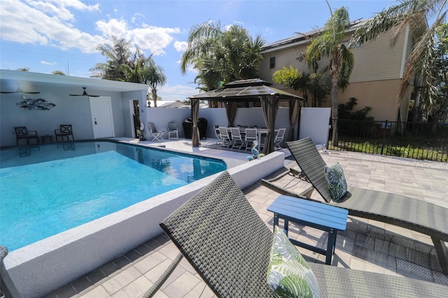 view of swimming pool with outdoor dining space, a patio, fence, a gazebo, and grilling area