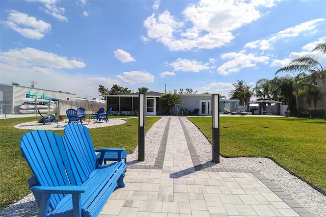 surrounding community featuring a patio area, a lawn, a fire pit, and fence