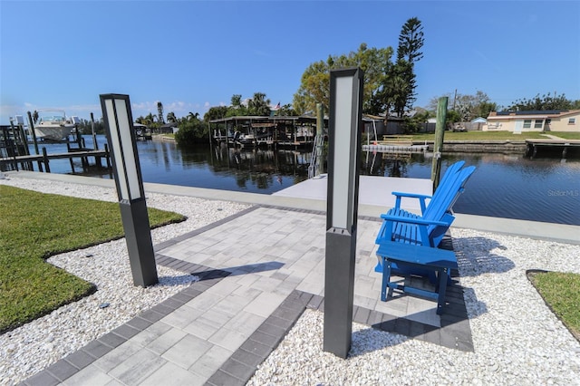 dock area with a water view and boat lift