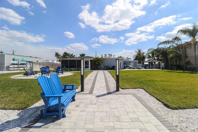 view of property's community with a patio area, a yard, and fence