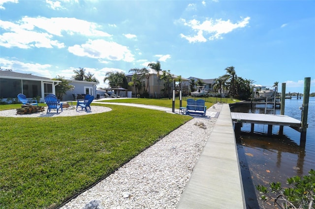 dock area featuring a residential view, a lawn, a fire pit, and a patio area