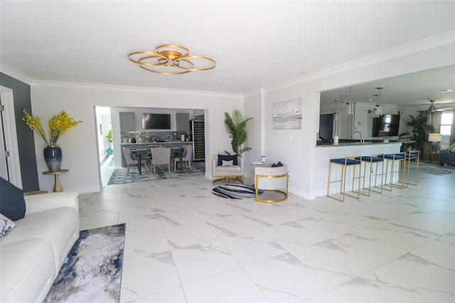 living room with marble finish floor, baseboards, and ornamental molding