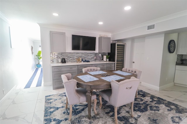 dining area featuring visible vents, marble finish floor, ornamental molding, recessed lighting, and baseboards