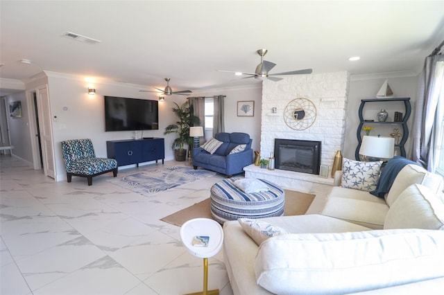 living area with visible vents, marble finish floor, a fireplace, and crown molding