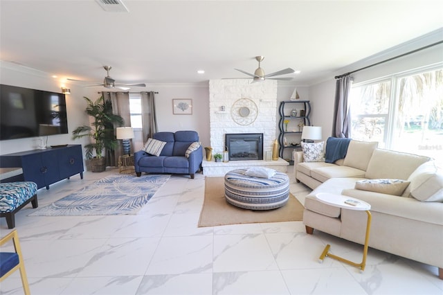 living area with marble finish floor, ceiling fan, and ornamental molding