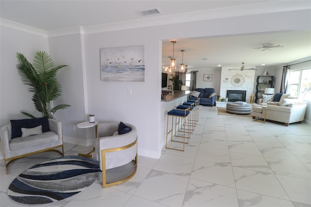 living room with visible vents, marble finish floor, a large fireplace, and ornamental molding